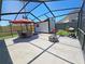 Relaxing screened patio with outdoor furniture, grill, fire pit, and a shed in the backyard at 4505 Alligator Dr, New Port Richey, FL 34653