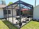 Inviting screened patio with grill and outdoor furniture, providing a relaxing space at 4505 Alligator Dr, New Port Richey, FL 34653