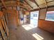 Spacious storage shed interior featuring wood plank flooring, ample shelving, and easy access at 4505 Alligator Dr, New Port Richey, FL 34653
