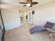 Cozy sunroom with tiled floors, chaise lounge, and doors leading to the kitchen at 4505 Alligator Dr, New Port Richey, FL 34653
