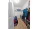 Walk-in closet features wood-look floors, shelving, and storage space for organizing clothes and personal items at 4505 Alligator Dr, New Port Richey, FL 34653