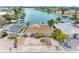 Aerial view of waterfront property, landscaped front yard, and well-maintained exterior at 455 115Th Ave, Treasure Island, FL 33706