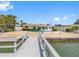 View from the dock of the backyard with a pool, lush landscaping, and water views at 455 115Th Ave, Treasure Island, FL 33706