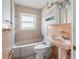 Bathroom featuring a tub and toilet combo, as well as storage, and a pedestal sink at 455 115Th Ave, Treasure Island, FL 33706