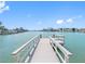 Private wooden dock with railings, offering direct access to the canal and waterways at 455 115Th Ave, Treasure Island, FL 33706