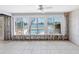 Living room with tile flooring and stunning waterfront views from large windows at 455 115Th Ave, Treasure Island, FL 33706