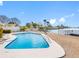 Backyard pool area with a waterfront view and lush landscaping at 455 115Th Ave, Treasure Island, FL 33706