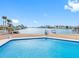 Relaxing pool area with scenic waterfront and dock views on a sunny day at 455 115Th Ave, Treasure Island, FL 33706