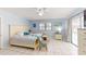 Bright bedroom features a queen-sized bed, tile floors, soft blue walls, and access to the outdoors at 5005 Puritan Rd, Tampa, FL 33617