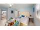 Bedroom with a large bed and chairs at a table next to a window at 5005 Puritan Rd, Tampa, FL 33617