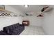 A walk-in closet is furnished with white wire shelving and a full-sized futon and baby's crib at 5005 Puritan Rd, Tampa, FL 33617