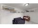 Spacious walk-in closet with white wire shelving, a futon, and a baby's crib for convenience at 5005 Puritan Rd, Tampa, FL 33617