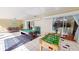 Large game room with pool table, ping pong, foosball, and access to various areas via sliding glass doors at 5005 Puritan Rd, Tampa, FL 33617