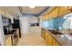 Modern kitchen with stainless steel appliances, granite counters, and bright lighting at 5005 Puritan Rd, Tampa, FL 33617