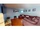 Cozy living room featuring a large sectional sofa, wood floors and decorative artwork on blue walls at 5005 Puritan Rd, Tampa, FL 33617