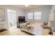 Tranquil bedroom featuring a full bed, TV, and an en suite bathroom in an open concept layout at 5005 Puritan Rd, Tampa, FL 33617