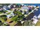 Aerial shot displays the property's canal-front location, including the dock, landscaping, and nearby boat lift at 5425 Bluepoint Dr, Port Richey, FL 34668