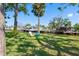 Backyard with lush grass, trees and waterfront views at 5425 Bluepoint Dr, Port Richey, FL 34668