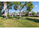 Backyard featuring a swing, mature trees and waterfront views at 5425 Bluepoint Dr, Port Richey, FL 34668