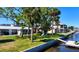 Backyard featuring well-manicured lawn, mature trees and waterfront views at 5425 Bluepoint Dr, Port Richey, FL 34668