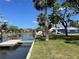 Tranquil backyard leading to a private dock, perfect for enjoying waterfront living and outdoor activities at 5425 Bluepoint Dr, Port Richey, FL 34668