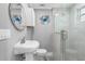 Bathroom featuring white fixtures, a vanity, toilet and glass shower with gray tiling at 5425 Bluepoint Dr, Port Richey, FL 34668