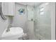 Bathroom featuring a modern shower with glass door and sink with elegant fixtures at 5425 Bluepoint Dr, Port Richey, FL 34668