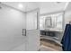 Bright bathroom featuring a tiled shower with glass door, modern sink and stylish decor at 5425 Bluepoint Dr, Port Richey, FL 34668