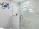 Modern bathroom shower featuring glass enclosure, tile surround, and decorative accents at 5425 Bluepoint Dr, Port Richey, FL 34668