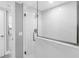 Bathroom with a glass door shower and marble-like tiled walls at 5425 Bluepoint Dr, Port Richey, FL 34668