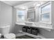 Bathroom featuring floating vanity, modern sink, stylish fixtures, and two windows at 5425 Bluepoint Dr, Port Richey, FL 34668