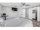 Stylish bedroom with a mounted TV and an organized closet system at 5425 Bluepoint Dr, Port Richey, FL 34668