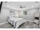 Bedroom featuring hardwood floors, a ceiling fan, and an accent mirror at 5425 Bluepoint Dr, Port Richey, FL 34668