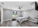 Comfortable bedroom with a ceiling fan and large window overlooking the neighborhood at 5425 Bluepoint Dr, Port Richey, FL 34668