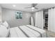 Bedroom featuring hardwood floors, a ceiling fan, and a closet at 5425 Bluepoint Dr, Port Richey, FL 34668