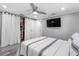Bedroom featuring hardwood floors, a ceiling fan, a closet, and a television at 5425 Bluepoint Dr, Port Richey, FL 34668