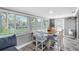 Bright dining area with large windows, stylish seating, and contemporary design at 5425 Bluepoint Dr, Port Richey, FL 34668
