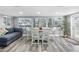 Bright dining area with large windows, stylish seating, and contemporary design at 5425 Bluepoint Dr, Port Richey, FL 34668