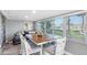 Inviting dining area with views, stylish furniture, and hardwood flooring at 5425 Bluepoint Dr, Port Richey, FL 34668