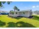 Charming home exterior with a well-kept lawn, complemented by fresh landscaping at 5425 Bluepoint Dr, Port Richey, FL 34668