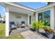 Inviting front porch with comfortable seating, decorative plants, and charming decor offers relaxation and curb appeal at 5425 Bluepoint Dr, Port Richey, FL 34668