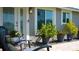 Charming entrance features seating, plants, and a stylish front door with glass detail, offering a warm welcome at 5425 Bluepoint Dr, Port Richey, FL 34668