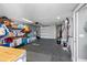 Garage with painted floor, shelving, and an open layout offering versatile uses at 5425 Bluepoint Dr, Port Richey, FL 34668