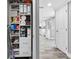 Hallway featuring storage with a view into the living space with an open floor plan at 5425 Bluepoint Dr, Port Richey, FL 34668
