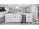 Open kitchen features a large island with sink and stainless steel dishwasher, and pendant lighting at 5425 Bluepoint Dr, Port Richey, FL 34668