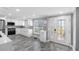 Bright kitchen features stainless steel appliances, tile backsplash, and white cabinets with lots of natural light at 5425 Bluepoint Dr, Port Richey, FL 34668