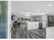 Open floor plan showcasing kitchen with modern cabinets, stainless steel appliances, and living room at 5425 Bluepoint Dr, Port Richey, FL 34668
