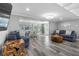 Stylish living room with wood-look tile flooring and comfortable seating with views of the backyard at 5425 Bluepoint Dr, Port Richey, FL 34668