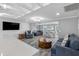 Open-concept living room featuring stylish decor, modern lighting, and a spacious dining area at 5425 Bluepoint Dr, Port Richey, FL 34668