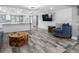 Stylish living room featuring a modern kitchen, open layout, and hardwood floors at 5425 Bluepoint Dr, Port Richey, FL 34668